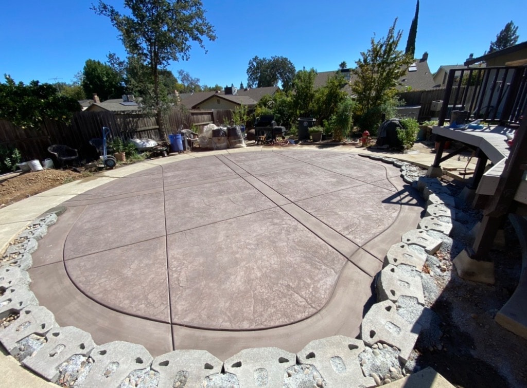 Concrete basketball court in residential backyard